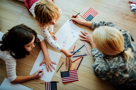 Image of military mom and kids coloring. Highlight military families in the month of April.
